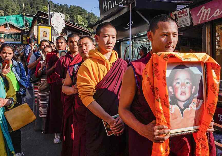 Buddhist monks holding a picture of Gedhun Choekyi Nyima, the 11th Panchen Lama, requesting his release from the Chinese Government