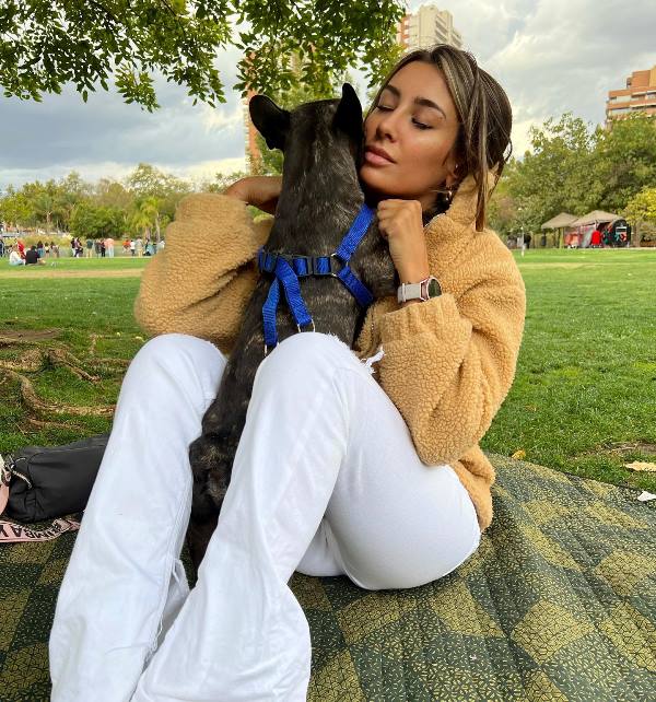 Camila Andrade posing with her pet dog