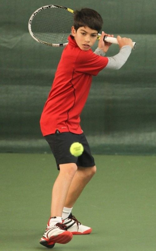 Carlos Alcaraz playing in a junior tennis competition