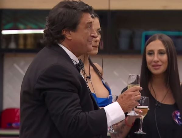 Carlos Toco holding a glass of champagne