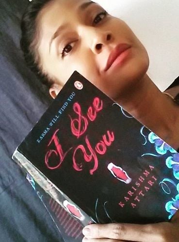 Carol Gracias holding a book