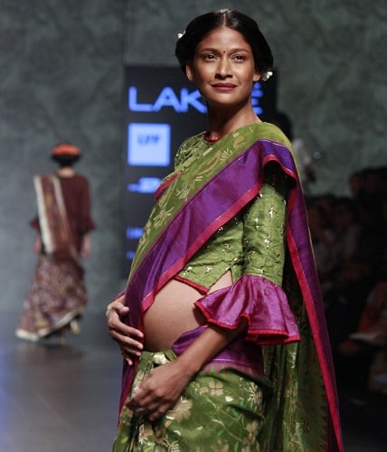 Carol Gracias walking the ramp with a baby bump