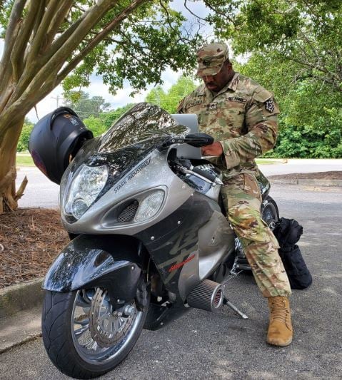 Cedric McMillan posing with his bike