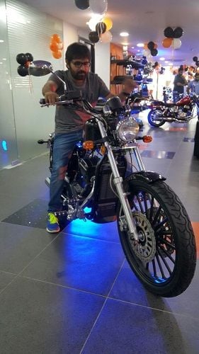 Chalaki Chanti sitting on his motorcycle