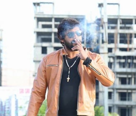 Chandrakanth while smoking a cigarette