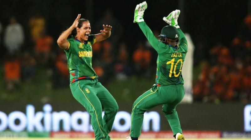 Chloé Tryon and Sinalo Jafta of South Africa celebrate getting the wicket of New Zealand cricketer Maddy Green during the 2023 ICC Women