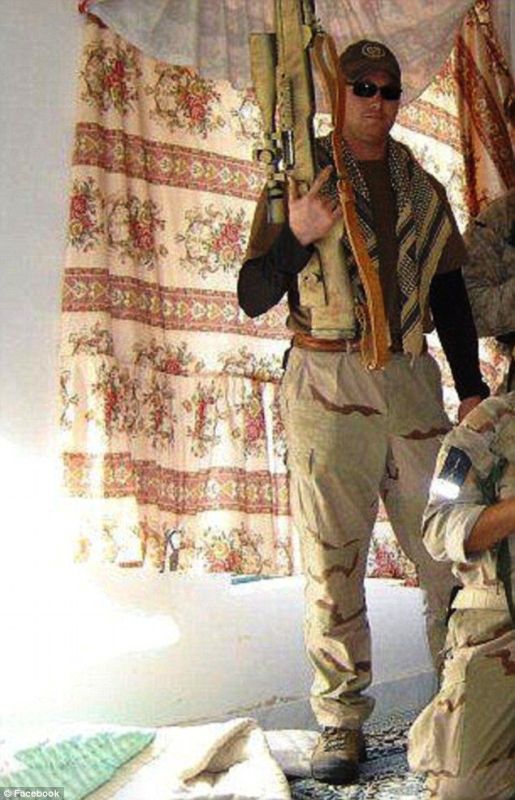 Chris posing for a photo with his sniper rifle