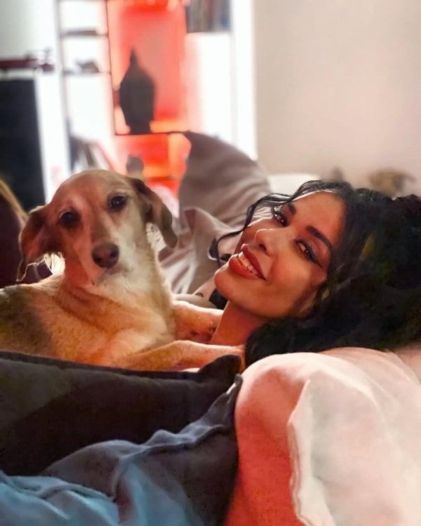 Christina Papadellis posing with her pet dog