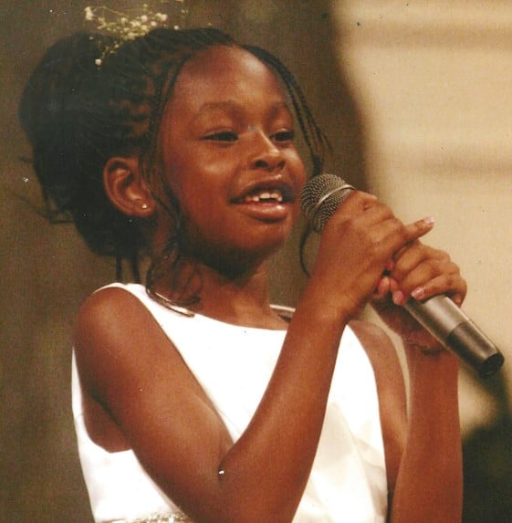 Coco Jones while singing in a reality show as a child