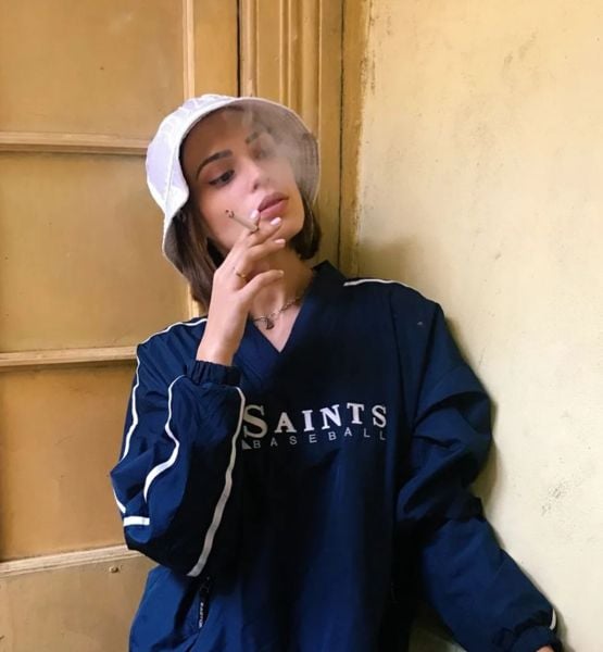 Constanza Capelli smoking a cigarette