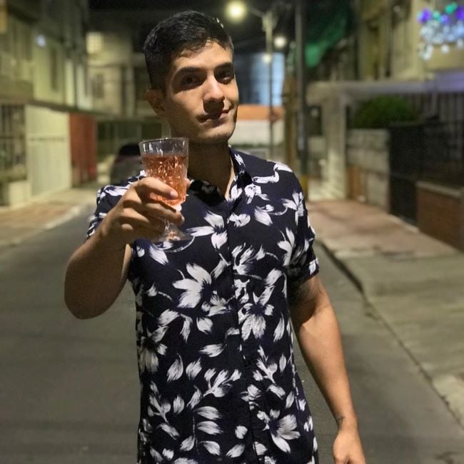 Cristian Pasquel holding a glass of alcohol