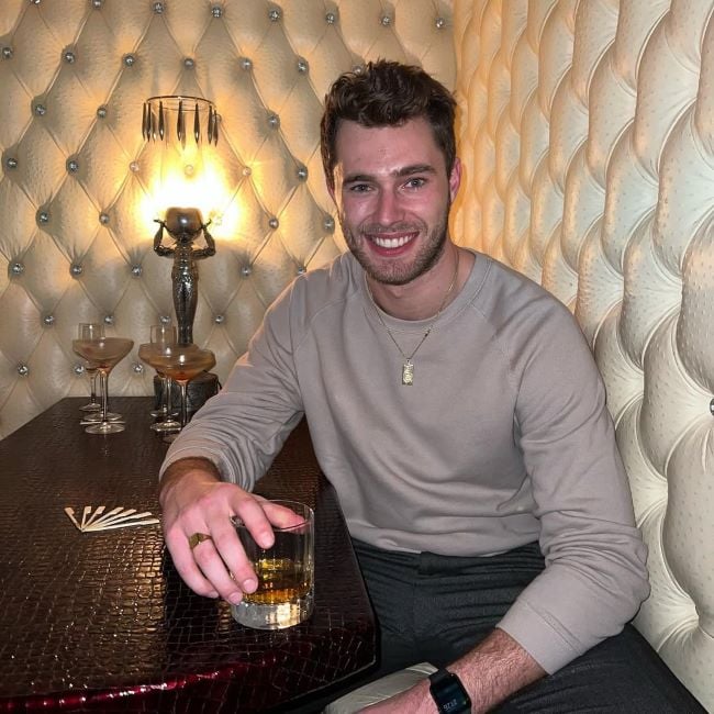 Curtis Pritchard holding a glass of malt whisky