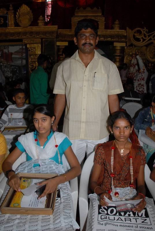 D. K. Suresh giving awards to underprivileged students