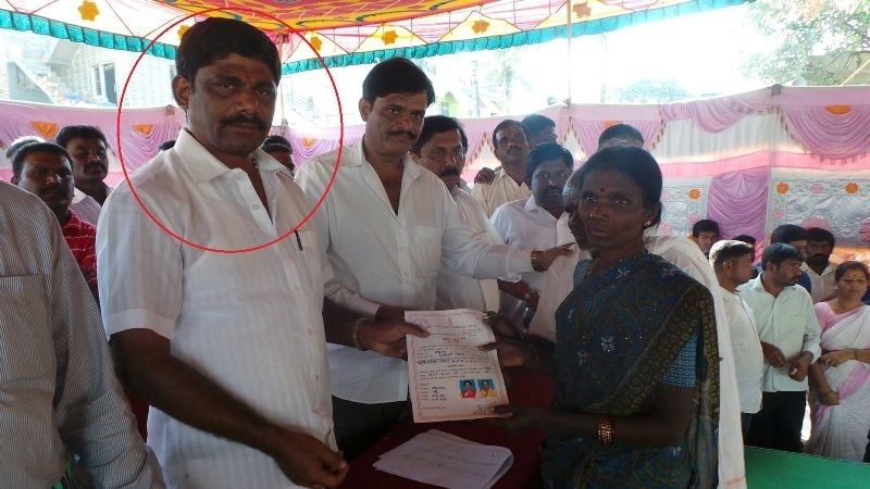 D. K. Suresh giving monetary aid to a woman
