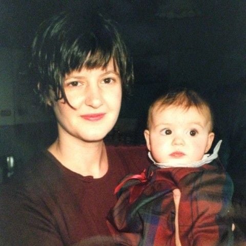 Daisy Edgar-Jones as a child in the lap of her Mother