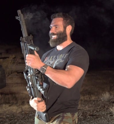 Dan Bilzerian posing with a gun