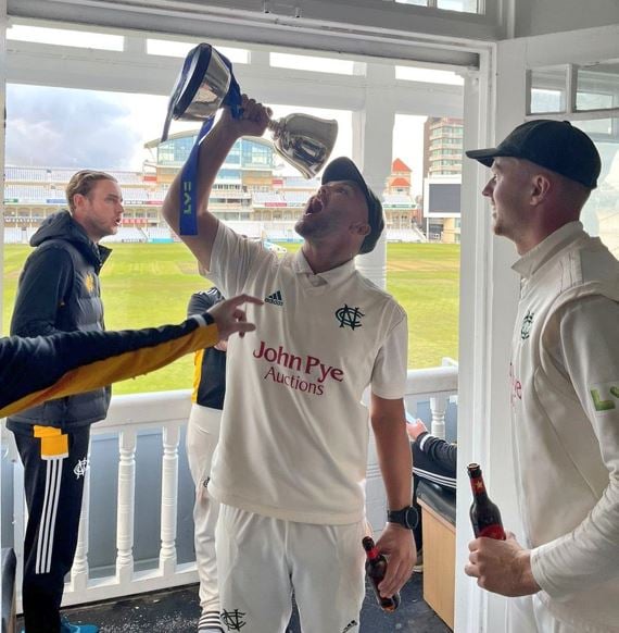Dane Paterson (holding the trophy) celebrating with his teammates after winning the 2022 Division Two