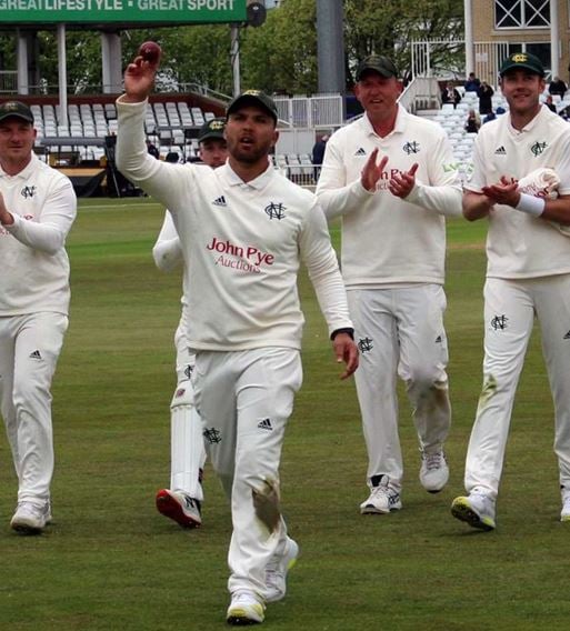 Dane Paterson showing ball to the crowd during a match for Nottinghamshire