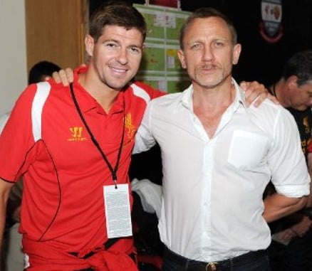 Daniel Craig while posing with a Liverpool F.C. player