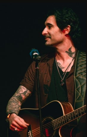 Daniel Weber while playing a guitar