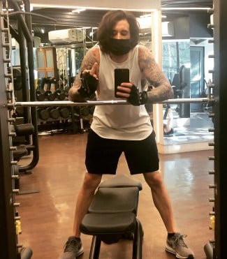 Daniel Weber while posing at a gym