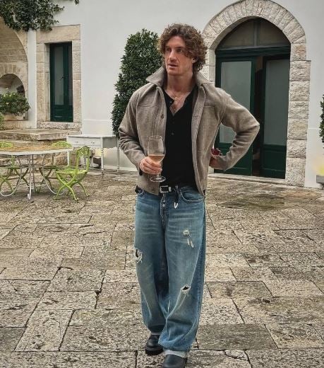 Danilo Mileto drinking wine during a party