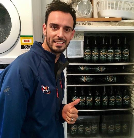Daryl Mitchell posing with beer storage