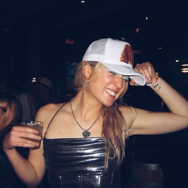 Dasha holding a glass of alcohol