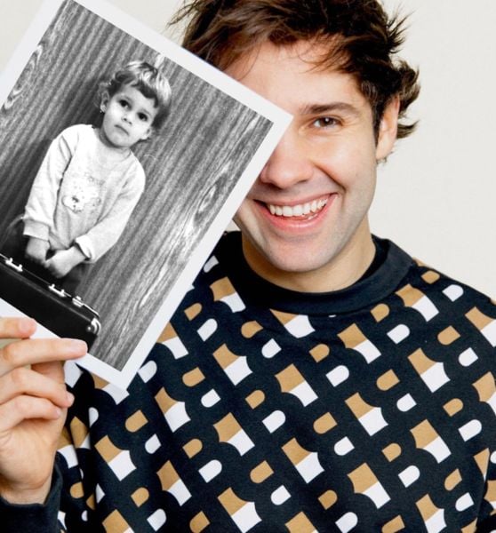 David Dobrik posing with his childhood photo