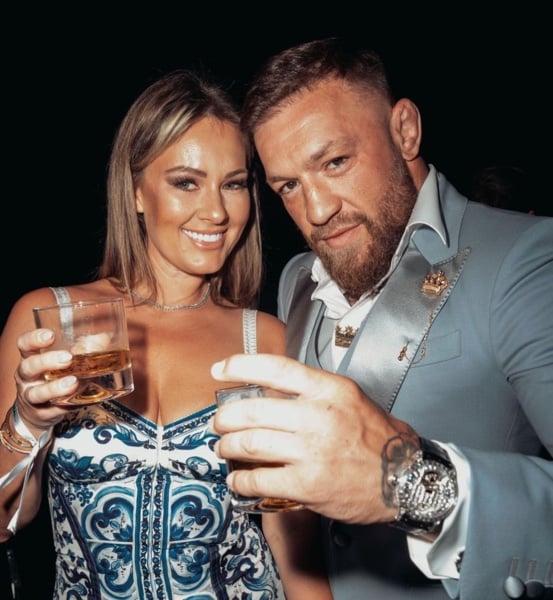 Dee Devlin and her boyfriend Conor McGregor drinking alcohol at a party