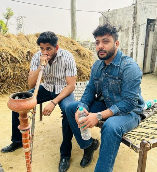 Deepak Chauhan (left) smoking hookah