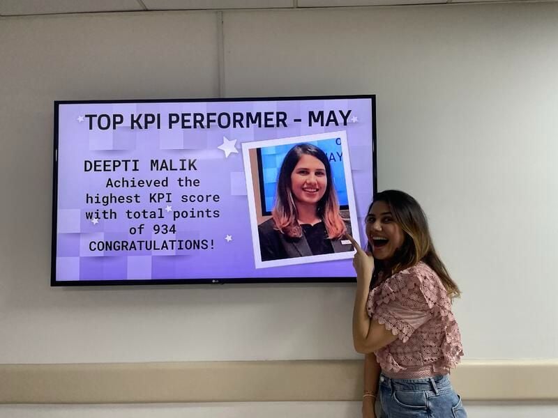 Deepti Mallik pointing out at the screen congratulating her for being the top performer