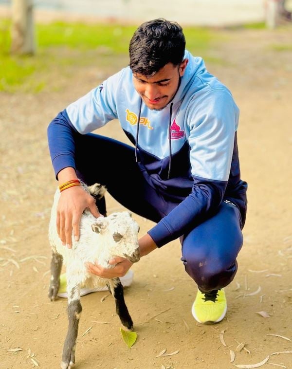 Devank Dalal with a baby goat