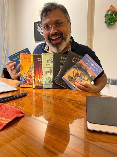Devdutt Pattanaik with his books