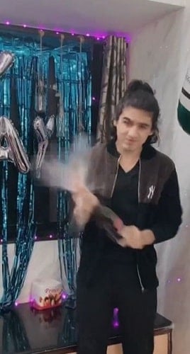 Devish Ahuja holding a bottle of champagne