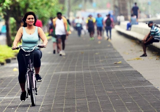 Devita Saraf riding a bicycle at Marine Drive in Mumbai