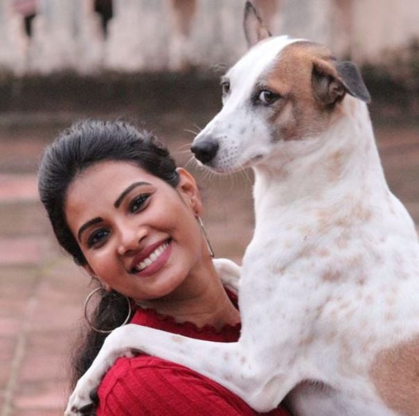 Dhivya Duraisamy with a dog named Dheera