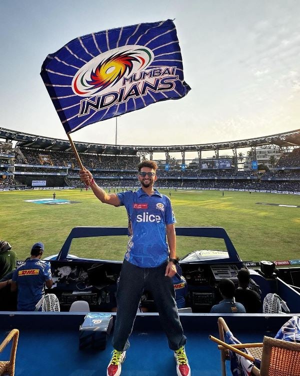 Dhruv Shah posing at a cricket stadium