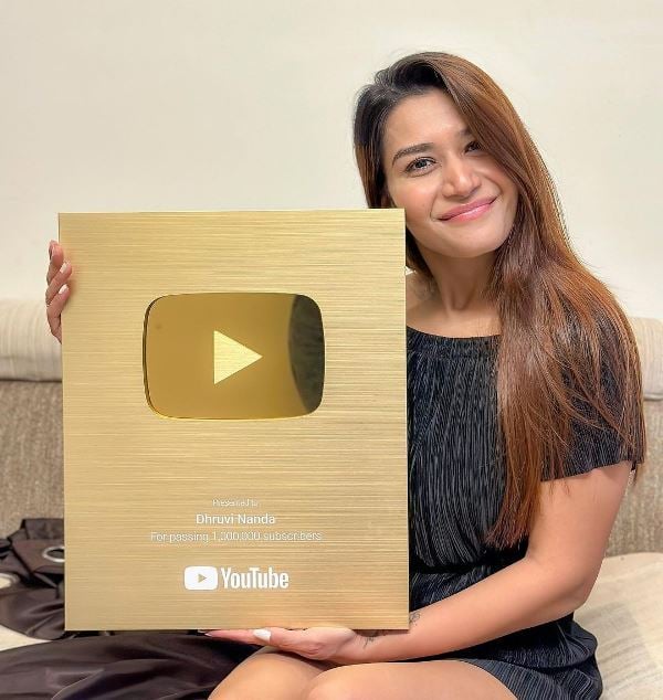 Dhruvi Nanda posing with the Golden Playbutton
