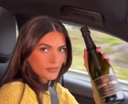 Diana posing with a bottle of alcohol