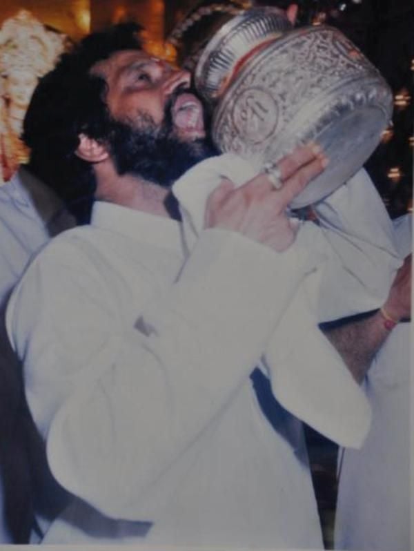 Dighe drinking water in a steel pitcher