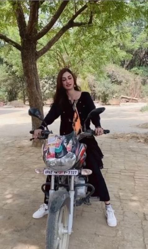 Diksha Singh riding a bike