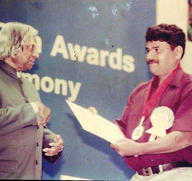 Dinesh Mangaluru with A. P. J. Abdul Kalam at an award ceremony