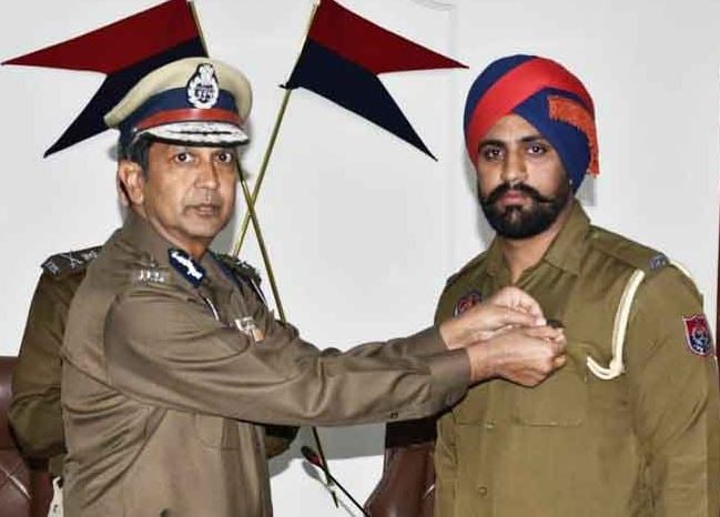 Dinkar Gupta awarding a police official