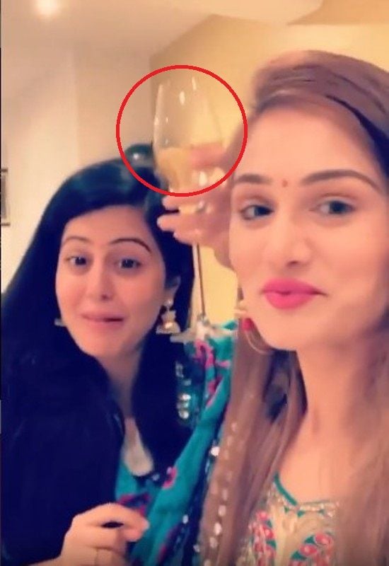 Divya Harjai holding a glass of wine