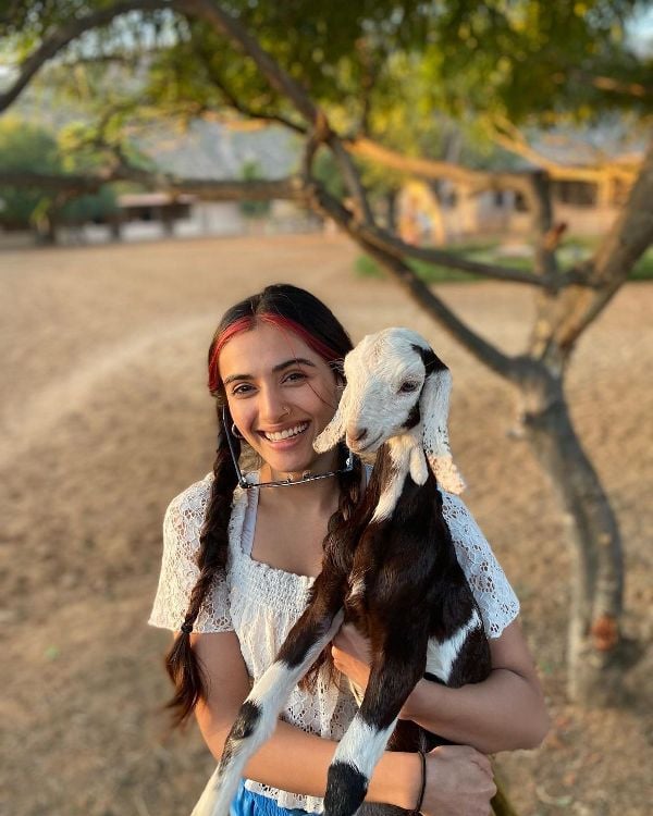 Divyansha Kaushik posing with a kid