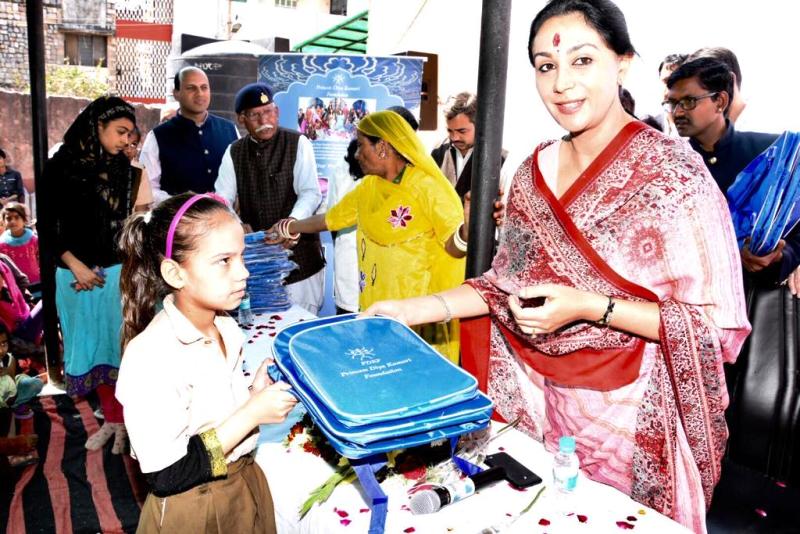 Diya Kumari distributing school bags to the children in the Jawahar Nagar slum area in Jaipur under Princess Diya Kumari Foundation (PDKF)