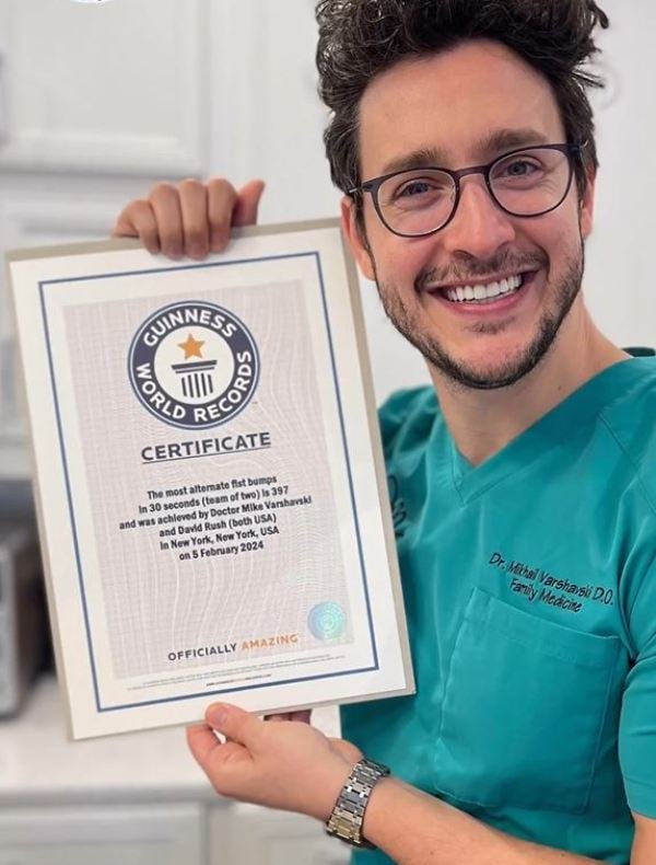 Doctor Mikes posing with his Guinness World Records certificate