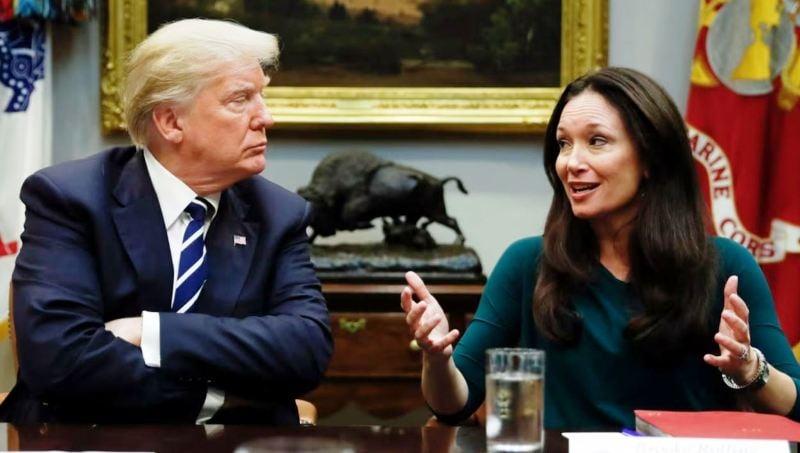 Donald Trump while looking at Brooke Rollins as she speaks during a prison reform roundtable at the Roosevelt Room in Washington in 2018