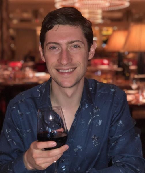 Dr Gary Linkov drinking wine at a restaurant